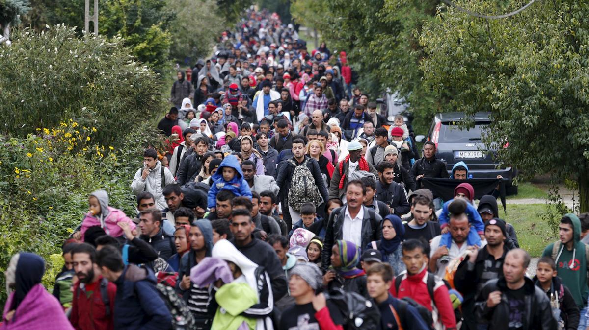 Refugees walk towards the Austrian border in Hegyeshalom, Hungary, on September 26, 2015. Heinz-Peter Bader / Reuters